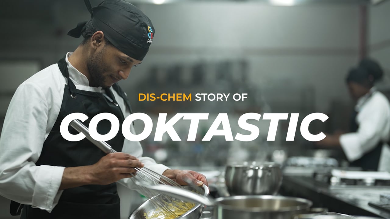 A Cooktastic chef carefully preparing food in a professional kitchen